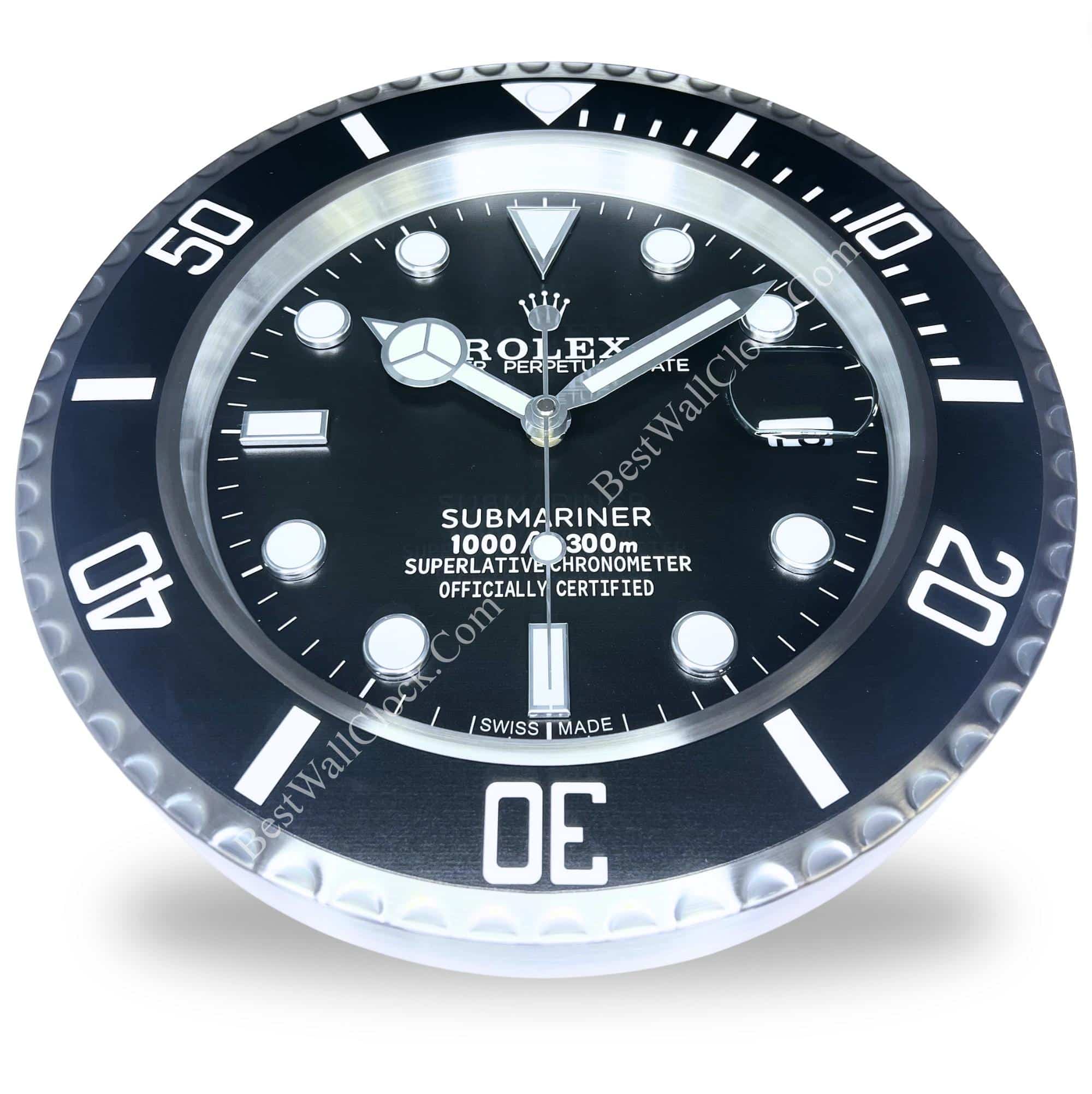 Close-up of a black Rolex Submariner watch face with silver detailing, white hour markers, and a date window with magnifier at 3 o'clock, surrounded by a black rotating bezel marked with white numerals and indices.
