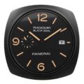 Panerai wall clock with a rounded square black frame, black dial, tan numerals, 