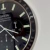 Close-up of an Omega Speedmaster Professional watch face showing detailed hour markers, subdials, and tachymeter scale on the bezel.