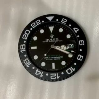 Close-up of a black Rolex Oyster Perpetual Date watch face with white hour markers and numerals on the bezel, showing the date as 30 and the time around 4:15.