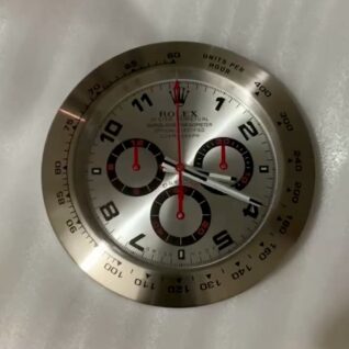 Close-up of a silver Rolex Oyster Perpetual Cosmograph watch face with black and red subdials, black numerals, and red second hands, showing the time as 2:17:00 with a white background.