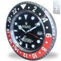 Rolex wall clock designed to resemble a Rolex GMT-Master II watch, featuring a black and red bezel, luminous hour markers, date display, and mounted on a wall with a metallic hanging bracket