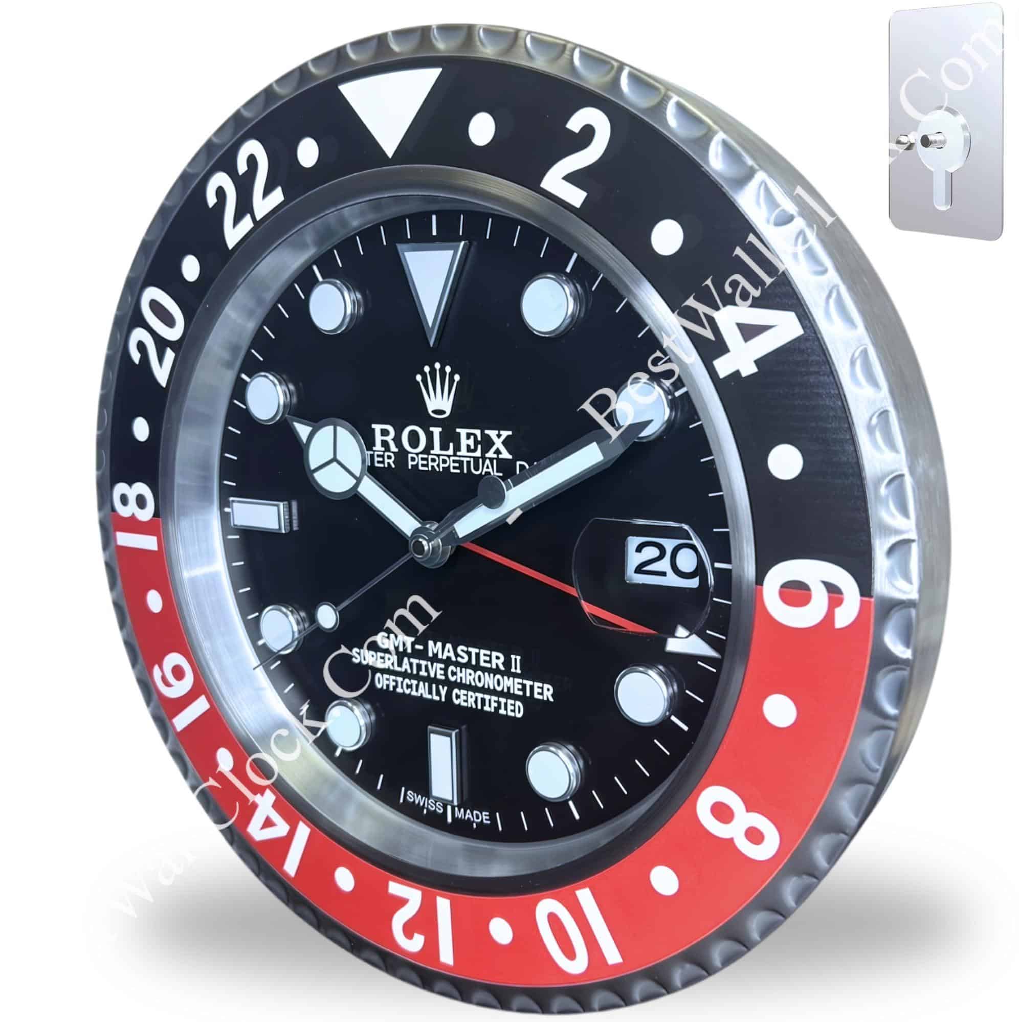 Rolex wall clock designed to resemble a Rolex GMT-Master II watch, featuring a black and red bezel, luminous hour markers, date display, and mounted on a wall with a metallic hanging bracket