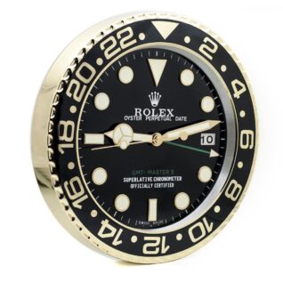 Rolex GMT-Master II wall clock with a black dial, black and gold bezel, luminous markers, Mercedes hands, Cyclops date-window, 24-hour scale.