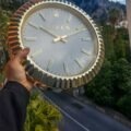 A close-up photo of the dial of a Rolex wall clock