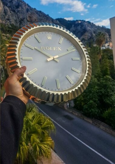 A close-up photo of the dial of a Rolex wall clock