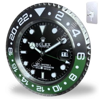 Round wall clock designed like a Rolex GMT Master II watch face with black and green bezel, white hour markers, and date display, mounted on a white wall.