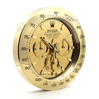 Rolex wall clock designed like a Daytona chronograph, featuring gold dial and bezel, three subdials, gold-tone hands, and tachymeter bezel.