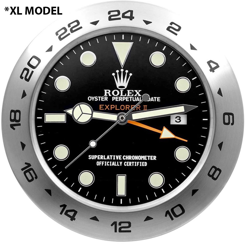 Rolex Explorer II-inspired wall clock with black dial, stainless steel bezel, black Mercedes hands, orange 24-hour hand, date display, and bold markings.