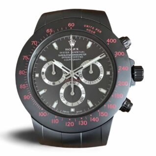 Matte black Rolex-inspired wall clock with a black dial, red tachymeter bezel markings, silver subdials, luminous hands, and decorative screw details.