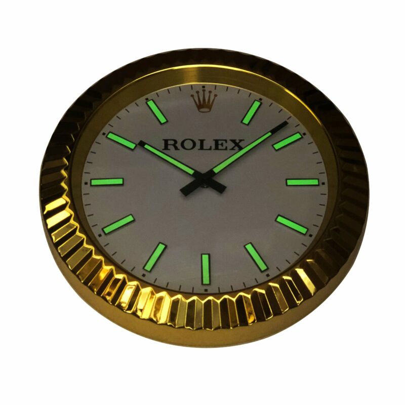 A ROLEX WALL CLOCK - GOLD OYSTER DATEJUST - GOLD - RL212 with green lights on it.