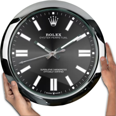 A person is holding a disproportionately large, oversized black Rolex Oyster Perpetual - Black watch with both hands.