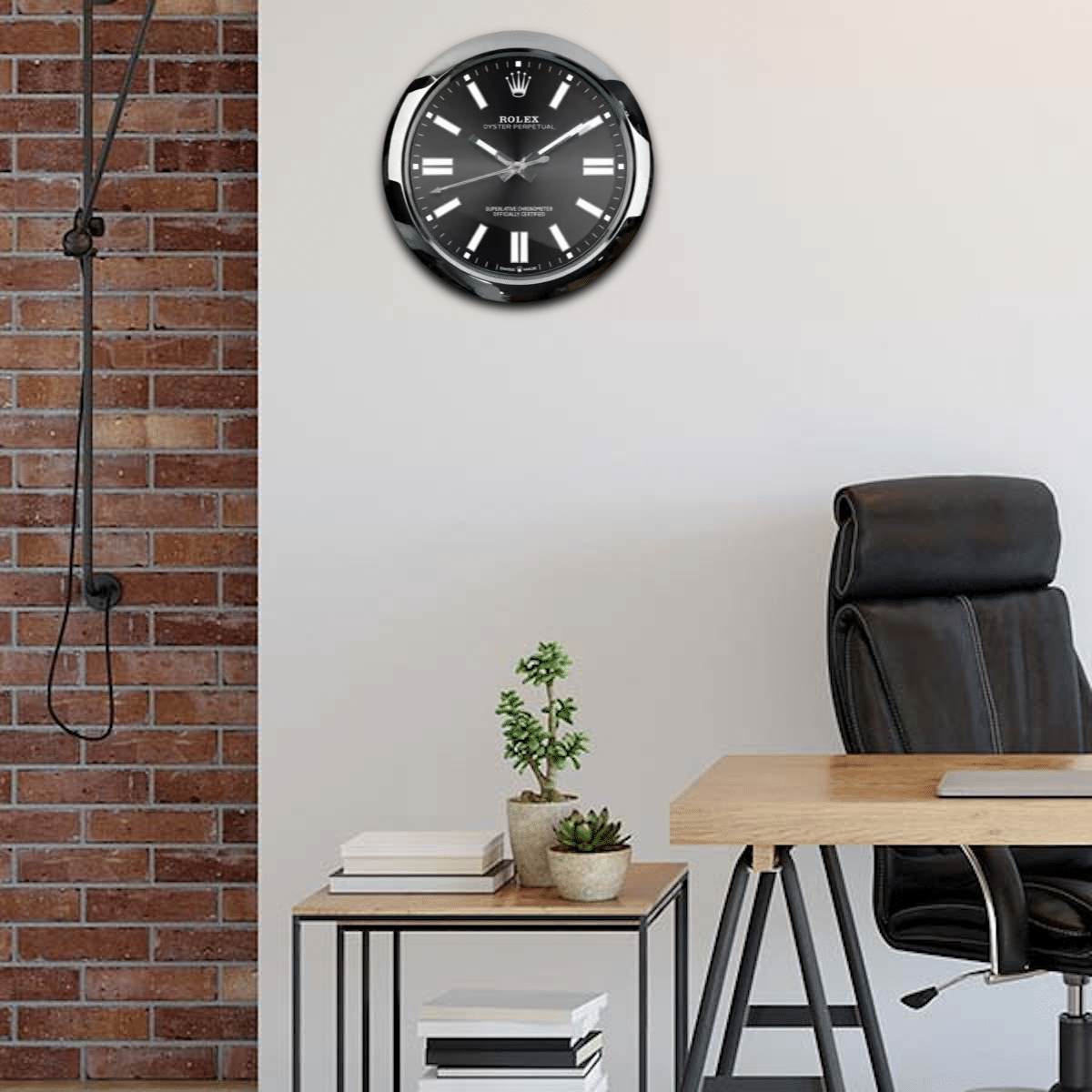 A modern home office with a brick wall, featuring an Oyster Perpetual - Black clock above the wooden desk with a small potted plant and books, a side table with magazines, and a black office