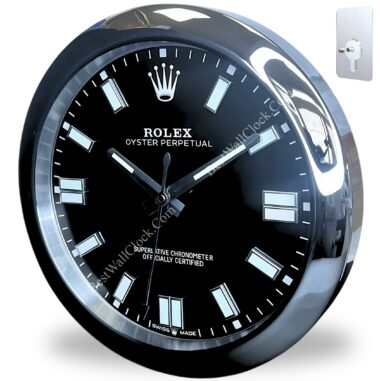 Close-up of a black and silver rolex wall clock with a shiny metallic frame, luminous rectangular hour markers, and the text ROLEX OYSTER PERPETUAL on the face, showing the time as 10:10:30, with a small metal mounting plate beside it