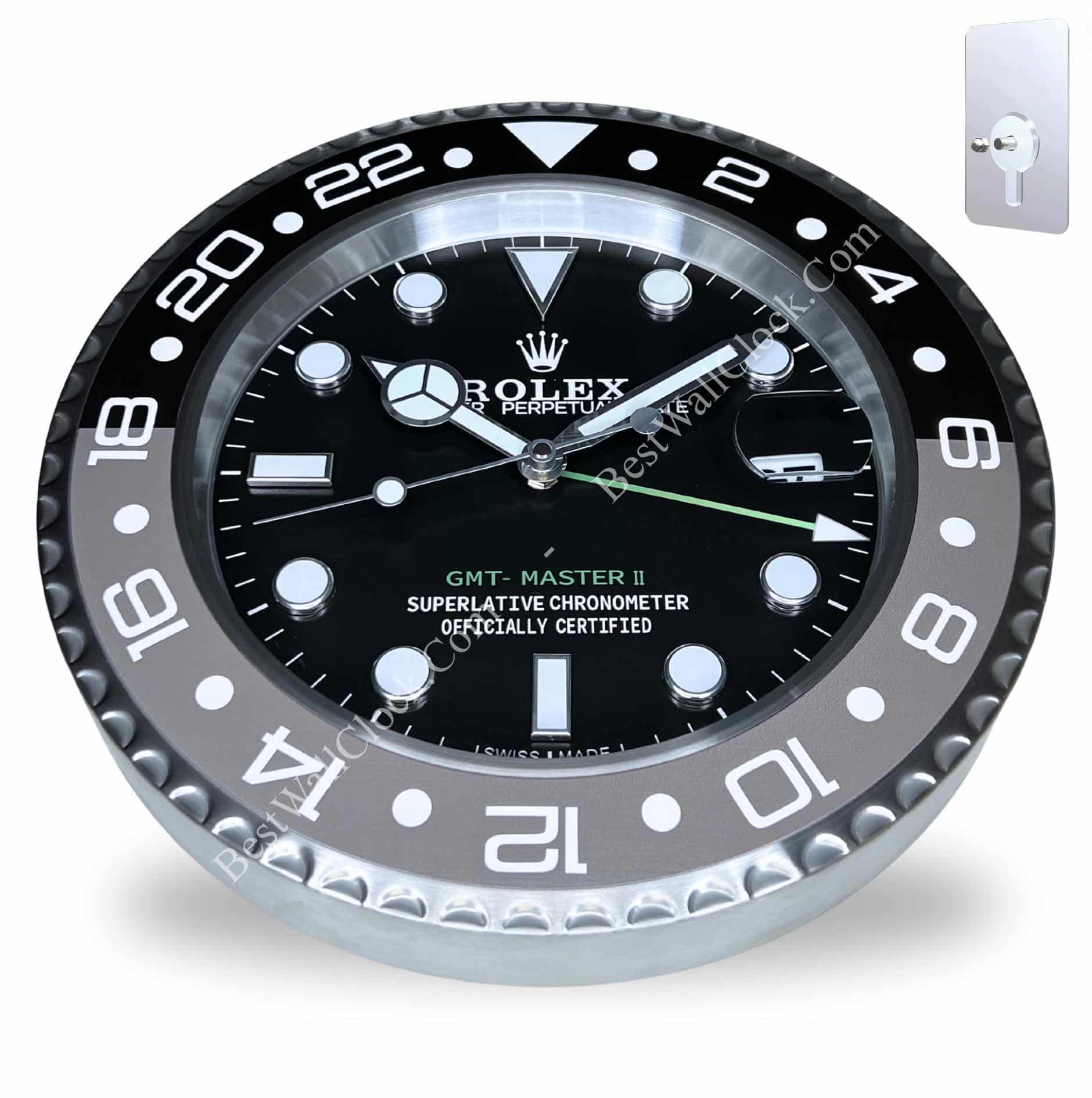 Wall clock designed to look like a black Rolex GMT-Master II watch face with white hour markers and silver hands, including a green GMT hand, mounted on a silver frame.
