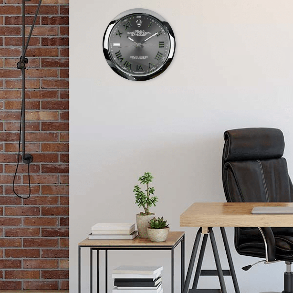 Modern office corner with a black leather chair, wooden desk, small side table holding two potted plants and stacks of books, a wall clock designed like a Rolex watch, and a section of exposed red brick wall with a hanging cord.