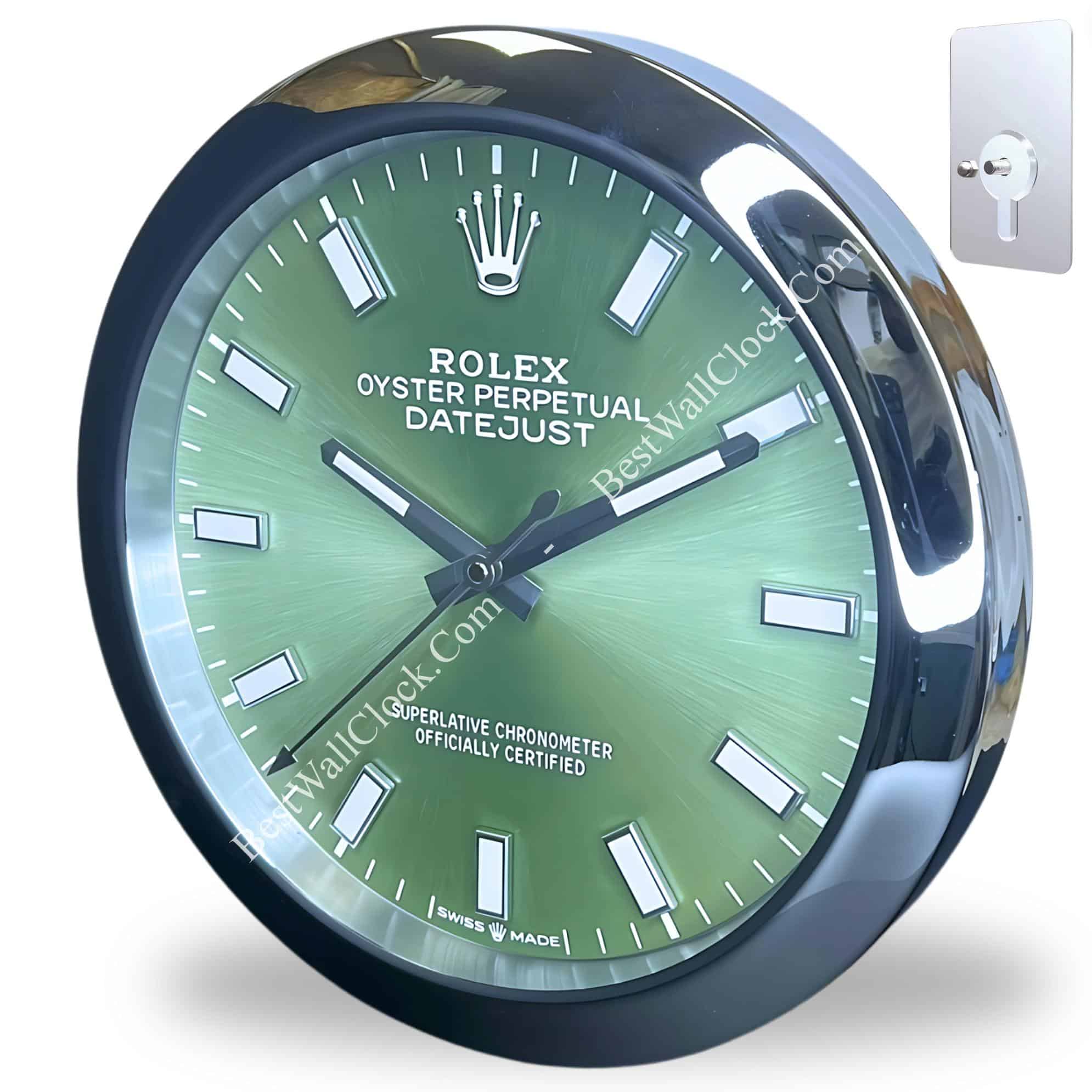 Round green Rolex Oyster Perpetual Datejust wall clock with silver hour markers and hands, encased in a reflective silver frame, alongside a metal wall mount for hanging.