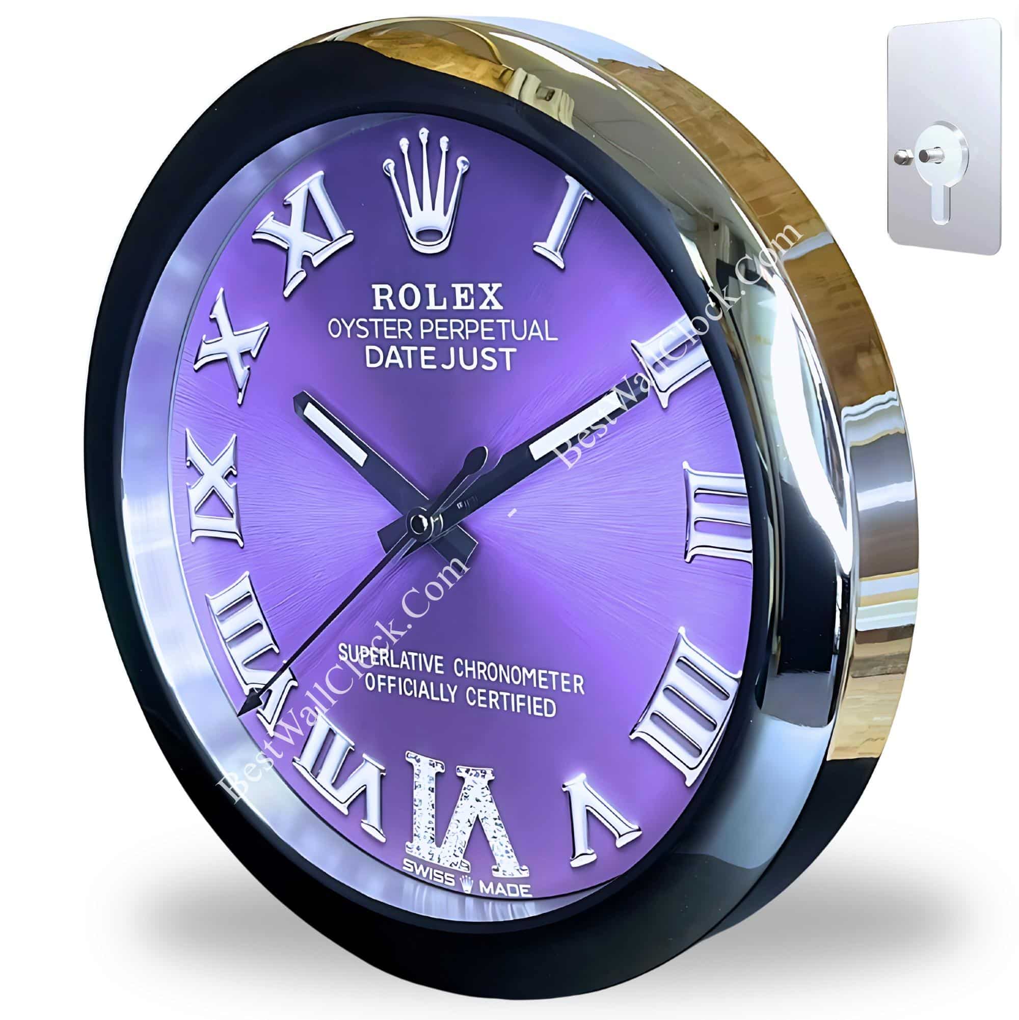 A round wall clock with a reflective silver rim and a purple face featuring silver Roman numerals and black hands, styled like a Rolex Oyster Perpetual Datejust watch, showing the time as approximately 10:11:43, with a small mounting bracket visible to the right side of the image.