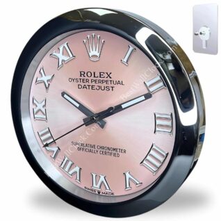 Wall clock designed like a Rolex Oyster Perpetual Datejust watch face with silver Roman numerals, black hour and minute hands, and a pink background, displayed with a transparent wall mount.