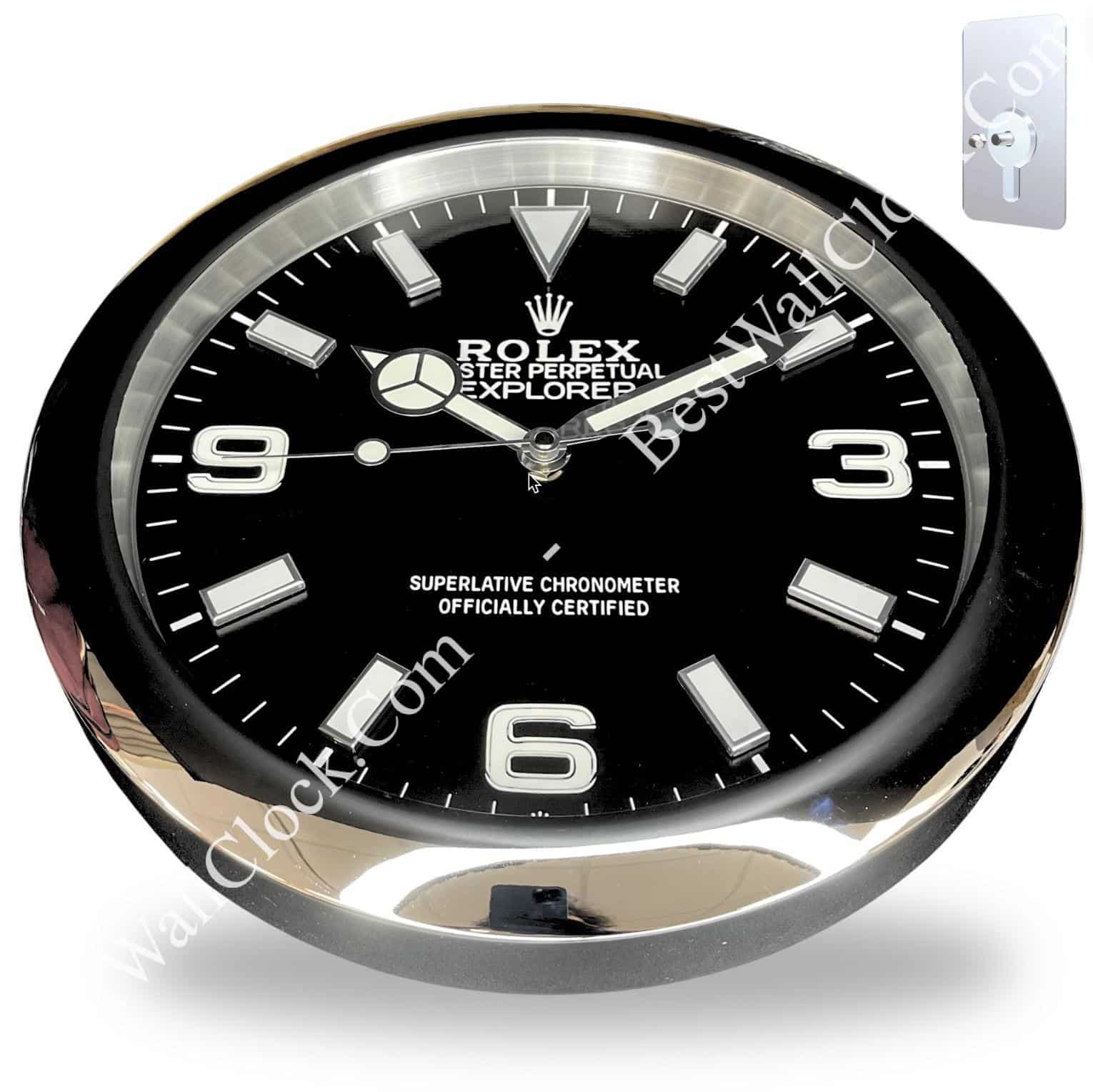 rolex wall clock with a black dial, silver hour markers and hands, featuring the text 'Rolex Oyster Perpetual Explorer' and 'Superlative Chronometer Officially Certified' inside a round silver and black frame.