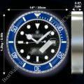 Blue and silver rolex wall clock with black dial, luminous hour markers, date display at 3 o'clock, and dimensions marked as 14 inches (35 cm) in diameter and 2.5 inches (7 cm) in depth, weighing 1.2 kg (2.6 lb).