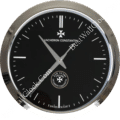 Vacheron Constantin wall clock with a silver frame, black dial, minimalist hour markers, sleek hands, and a 250-year anniversary emblem.
