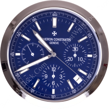 Vacheron Constantin wall clock with a polished silver frame, deep blue dial, bold white indices, three subdials, and sleek luminous hands.