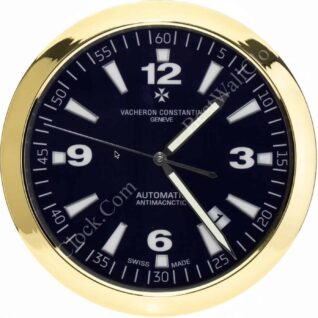 Rolex well clock showing a gold-framed black dial with white hour markers and the time at approximately 1:24