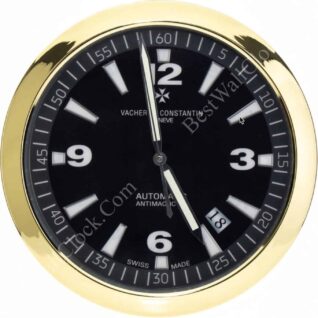 rolex well clock showing a gold-framed black dial with white hour markers and hands pointing near 12 and 5 with a date window at 4, emphasizing automatic and Swiss made features