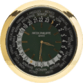 Patek Philippe wall clock with a gold frame, green dial, world time display, gold indices, dual hands, and a 24-hour scale.