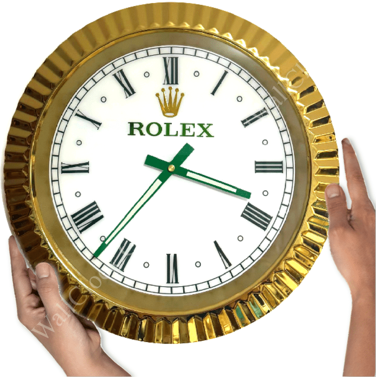 rolex well clock featuring a round gold frame, white face with black Roman numerals, green hour and minute hands, and two hands holding it on either side