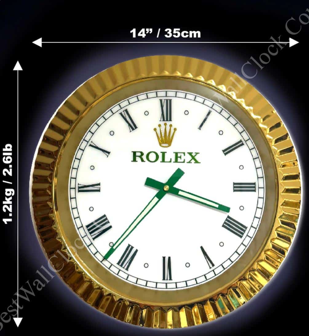 Rolex well clock featuring a round white dial with black Roman numerals and green hands, set in a gold bezel, with measurements 14 inches (35 cm) diameter and weight 1.2 kg (2.6 lbs) indicated around it