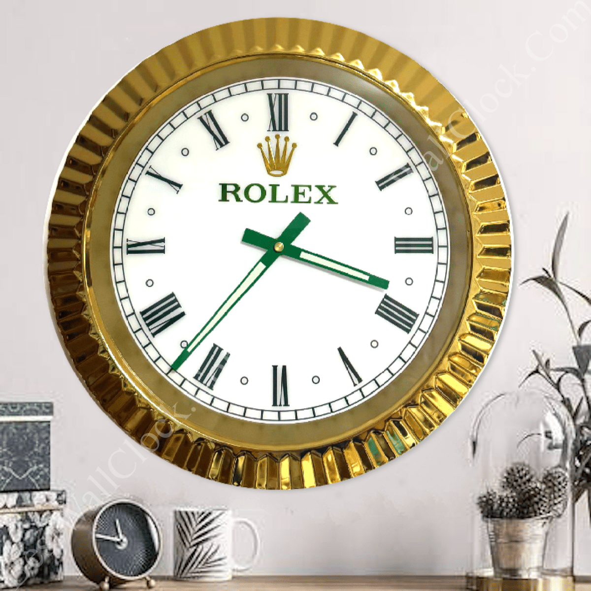rolex well clock featuring a gold-framed wall clock with Roman numerals and green hands, displayed above a tabletop with a small clock, a mug, and decorative plants, rolex well clock