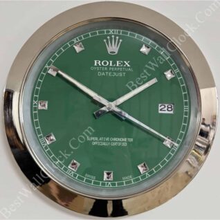 rolex well clock showing green face with silver hour markers and hands in a round chrome frame indicating time at 10:11:40 with date window at 3 o'clock
