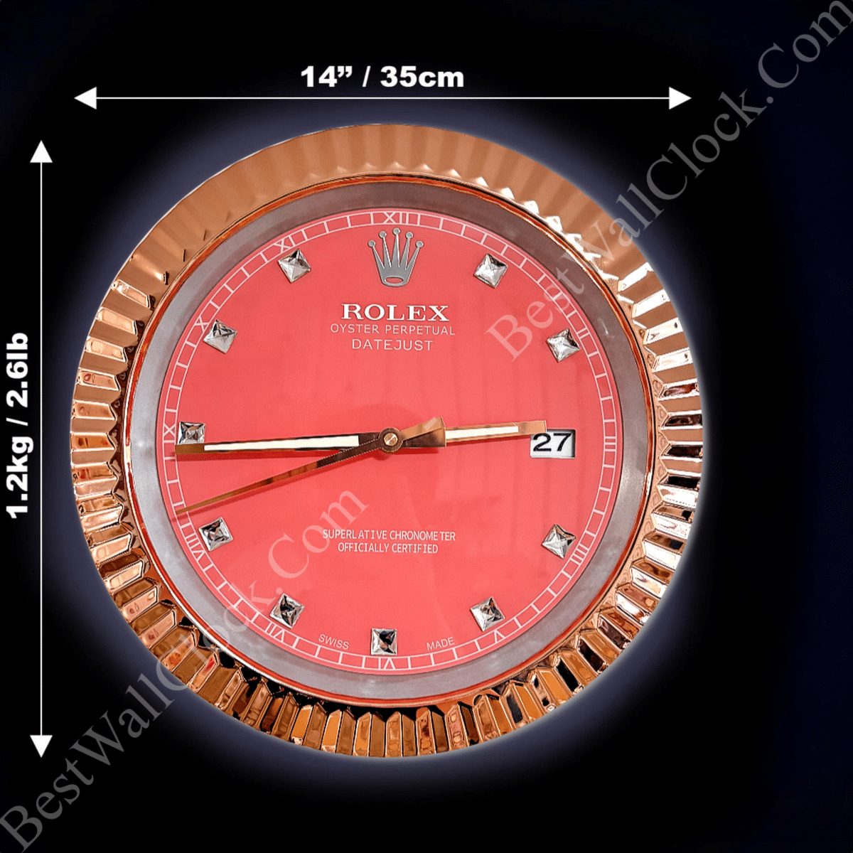 Round wall clock designed like a Rolex Oyster Perpetual Datejust watch face with a red background, diamond hour markers, gold fluted frame, and white text, measuring 14 inches (35 cm) in diameter and weighing 1.2 kg (2.6 lbs) on a black background.