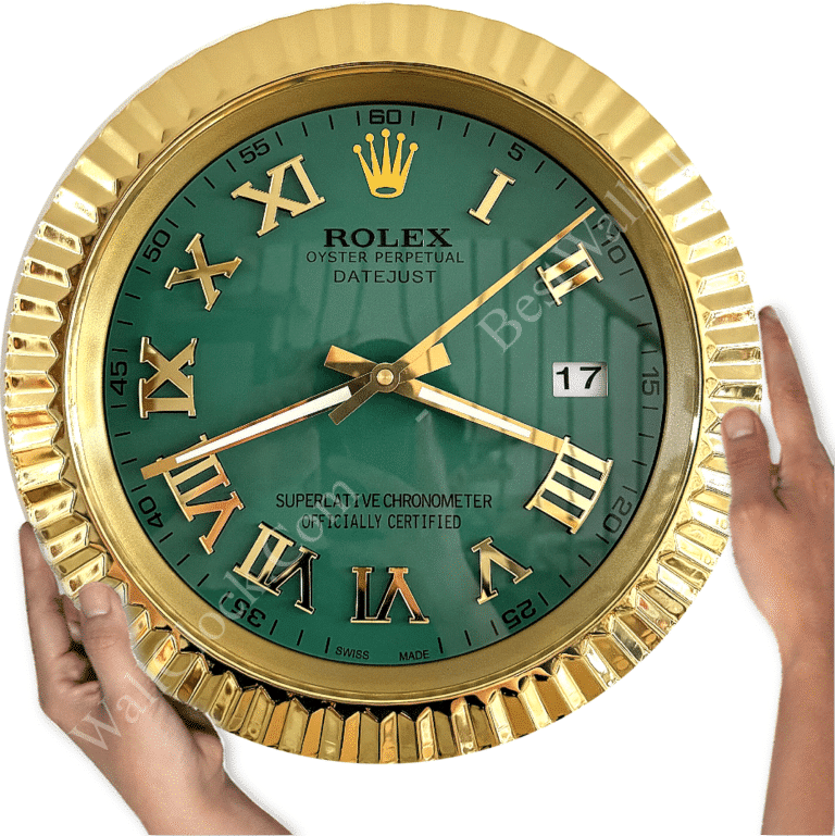 Close-up of a gold-frame Rolex wall clock with a green face, gold Roman numerals, and date display showing 17, held by two hands on either side.