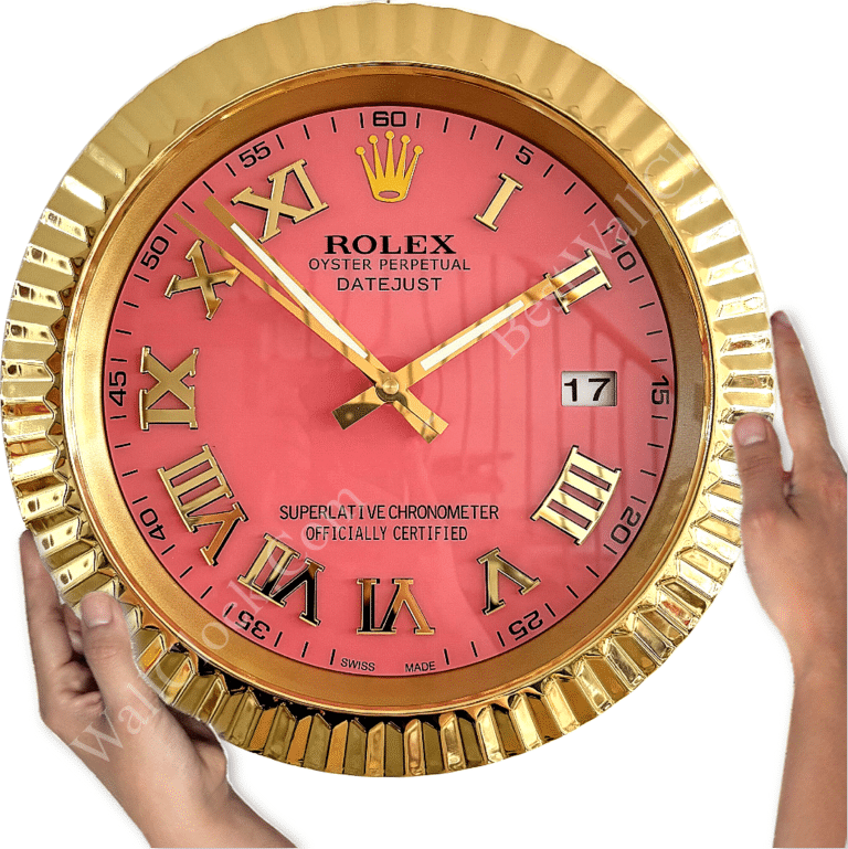 Pink-faced Rolex wall clock with gold Roman numerals and hands, held by two hands, showing the time at approximately 10:08 and displaying the date 17 in a rectangular window.