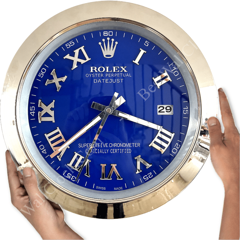 Close-up of a round Rolex wall clock with a blue face, silver Roman numerals, and a silver frame, showing the time as approximately 7:16, held by two hands on either side.