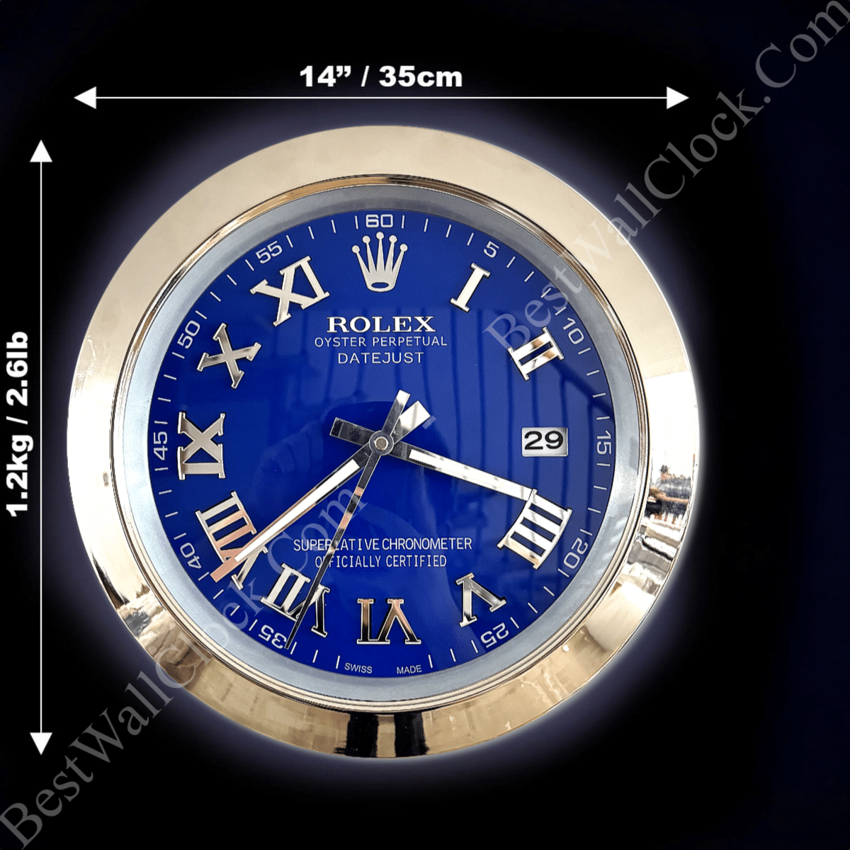 Round wall clock with a blue face, gold Roman numerals, and three silver hands, set in a gold frame with dimensions 14 inches (35 cm) diameter and weight 1.2 kg (2.61 lb), displaying the brand name 'Rolex Oyster Perpetual Datejust' and a date window showing 29.