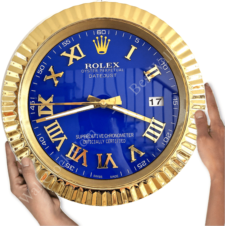 Round wall clock styled like a Rolex watch with a gold fluted bezel, blue face, gold Roman numerals, and gold hands, showing the time as 8:45, held by two hands against a white background