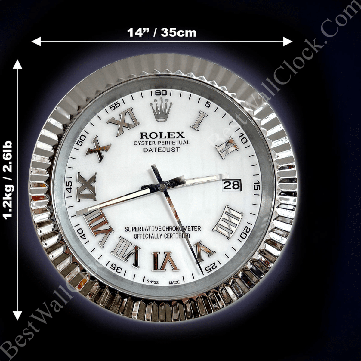 Silver-framed Rolex-style wall clock with white face, Roman numerals, date window showing 28, and black hour, minute, and second hands, with dimensions 14 inches (35 cm) diameter and 1.2 kg (2.61 lb) weight indicated