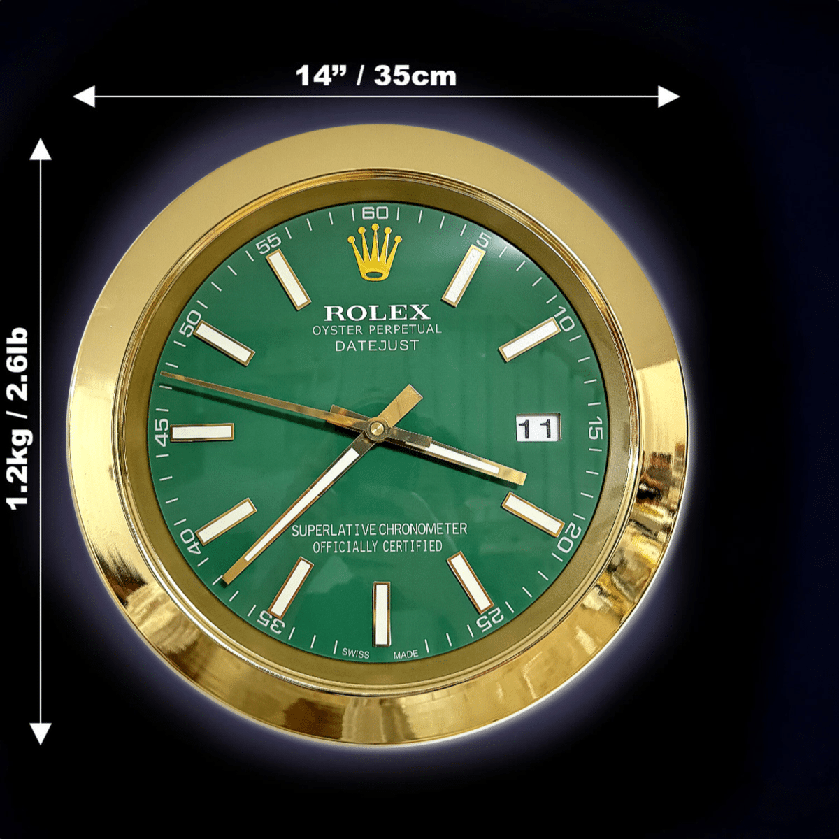 Round Rolex wall clock with a green face, gold frame, and white hour markers, showing the time as 3:36:51, with dimensions of 14 inches (35 cm) in diameter and weighing 1.2 kg (2.6 lb) indicated by arrows on a black background.