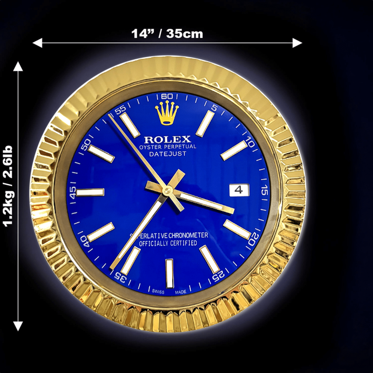 Rolex Oyster Perpetual Datejust wall clock with a blue face and gold fluted bezel, measuring 14 inches (35 cm) in diameter and weighing 1.2 kg (2.6 lb) against a black background.