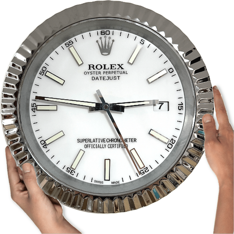 Close-up of a white Rolex wall clock with silver ridged frame being held by two hands, showing the time as 2:46:27 and a date of 7