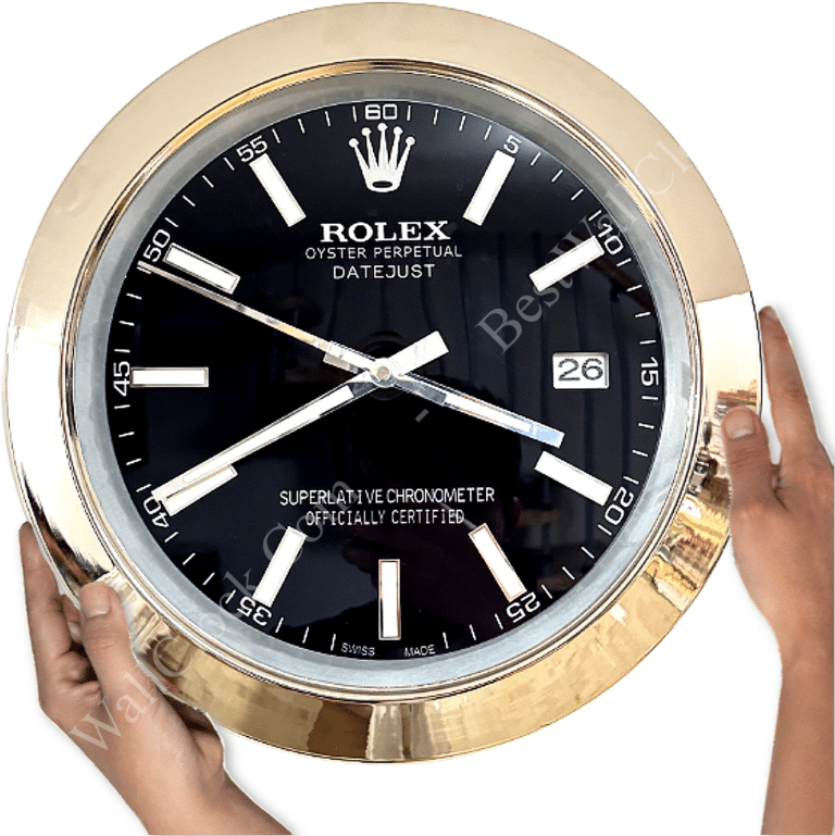 Large round wall clock designed to resemble a Rolex Oyster Perpetual Datejust watch with a black face, silver hour markers, white hands, date display at 3 o'clock, and a gold-tone frame held by two hands on either side