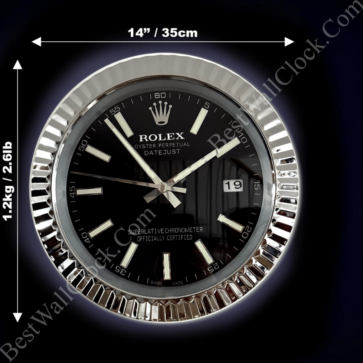 Close-up of a Rolex Oyster Perpetual Datejust wall clock with a black face, silver hour markers, and date display showing 19, with measurements indicating 14 inches (35 cm) in diameter and weight of 1.2 kg (2.6 lb)
