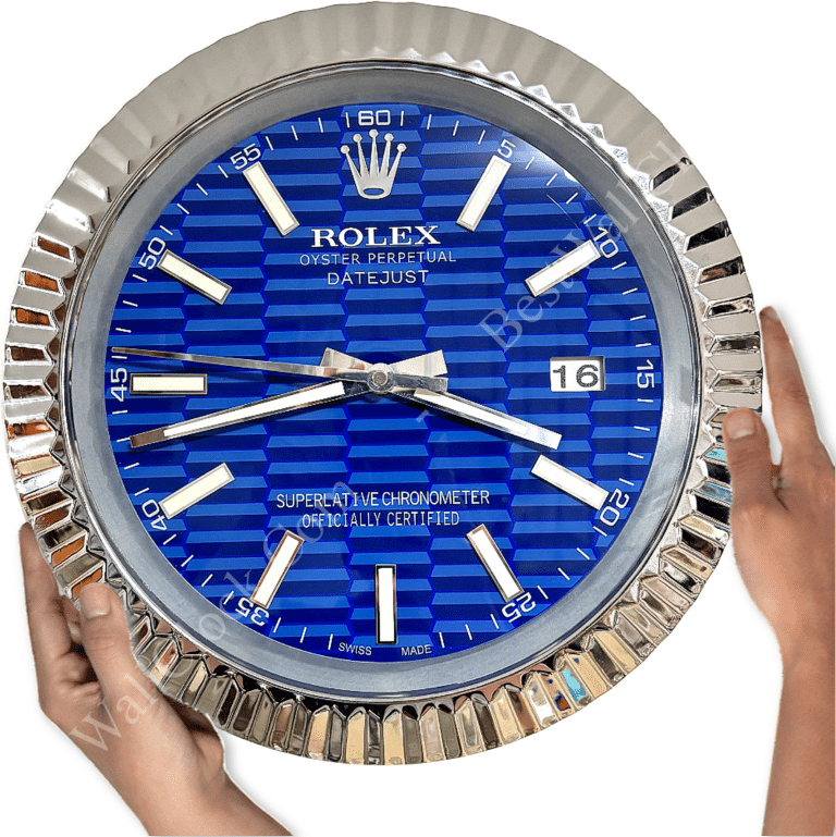 Hands holding a large wall clock designed like a Rolex Oyster Perpetual Datejust watch with a blue patterned face, silver hour markers, and date display showing 16.