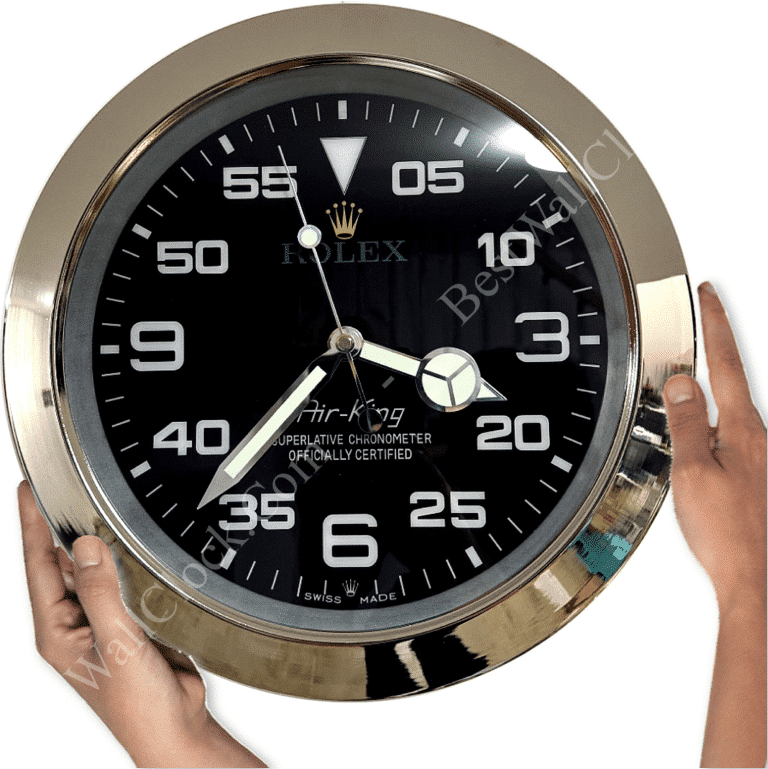 Hands holding a large round Rolex Air-King wall clock with black face, white numerals, and silver frame showing time at approximately 03:38:55.