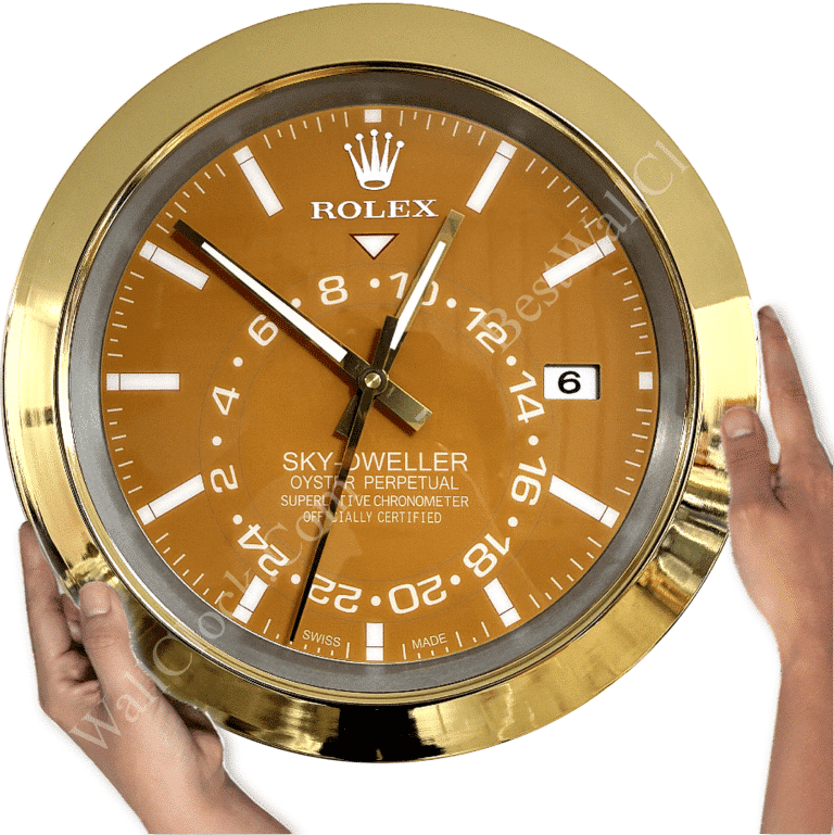 Close-up of a gold-framed Rolex Sky-Dweller wall clock with a brown dial, white hour markers, and date display, held by two hands on either side