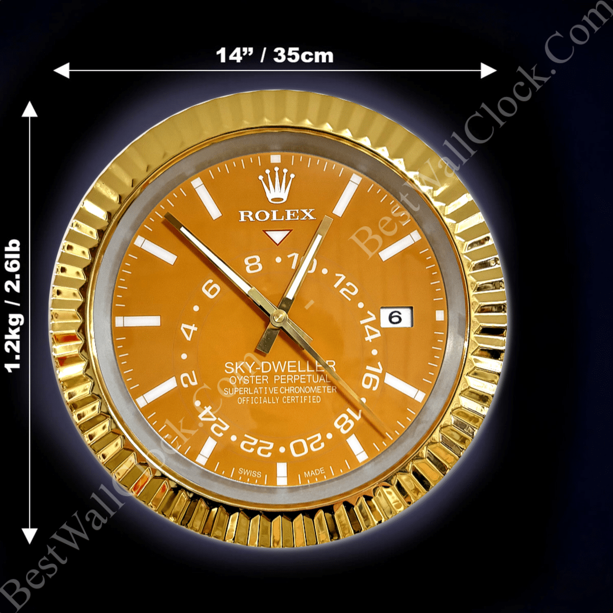 Gold-framed Rolex Sky-Dweller wall clock with orange face, white hour markers and hands, date display, and measurements indicating 14 inches (35 cm) diameter and weight of 1.2 kg (2.6 lb) on a dark background.
